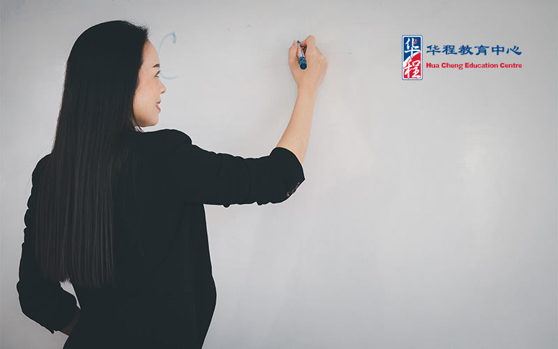 Image of female Lecturer writing on whiteboard
